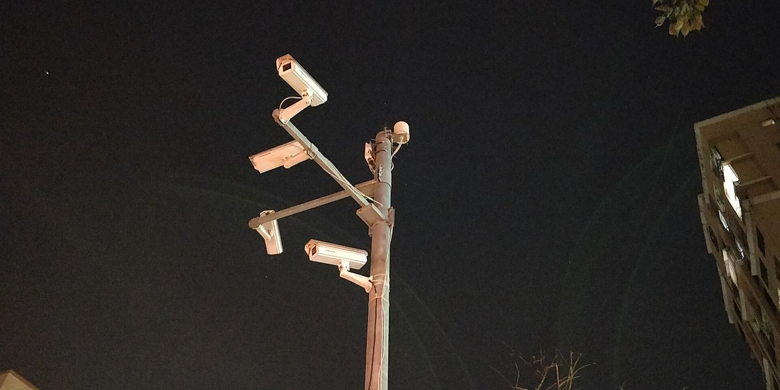 Security cameras mounted on a pole at night